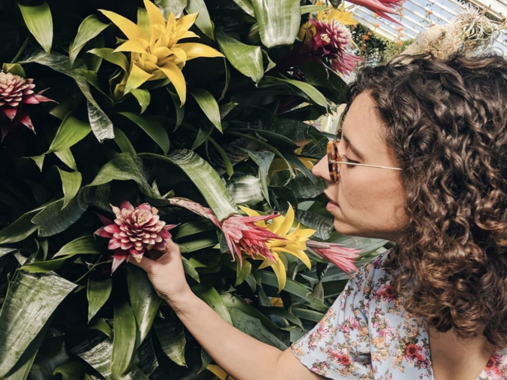 Rita smelling a flower